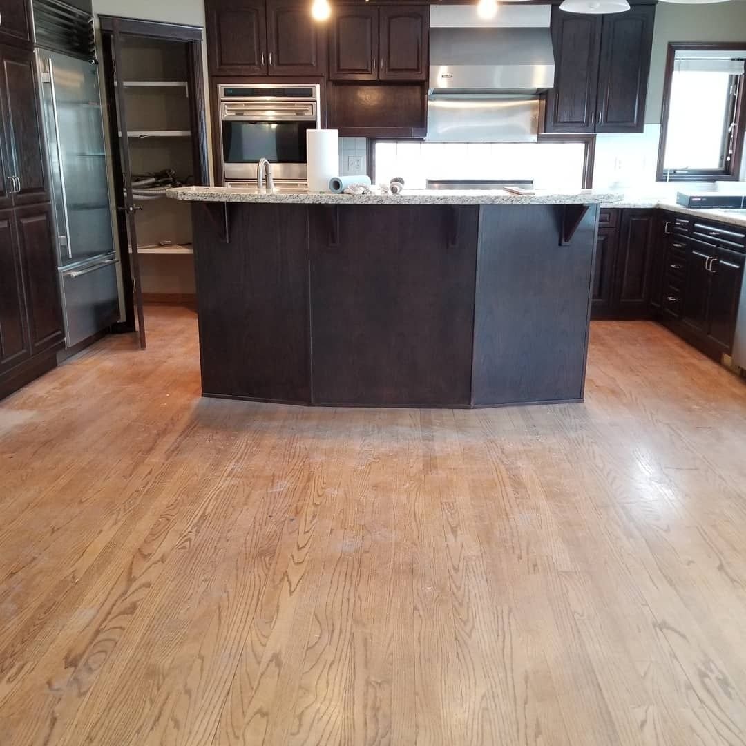 Red oak kitchen hardwood floor after refinishing and staining by Wildrose Hardwood, Calgary Airdrie