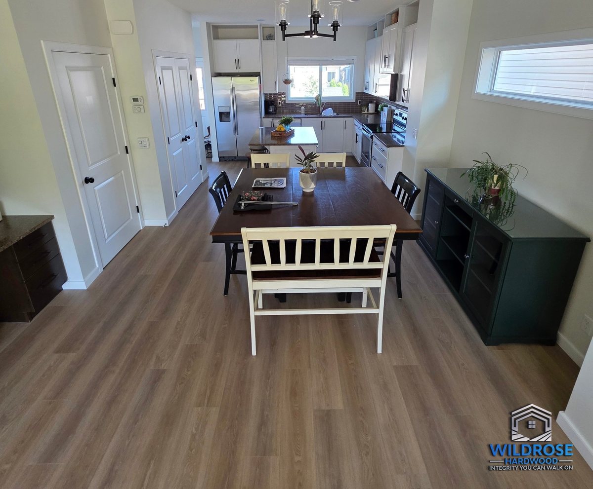 Vinyl plank flooring installation in an open-concept dining area, Wildrose Hardwood, Airdrie Alberta